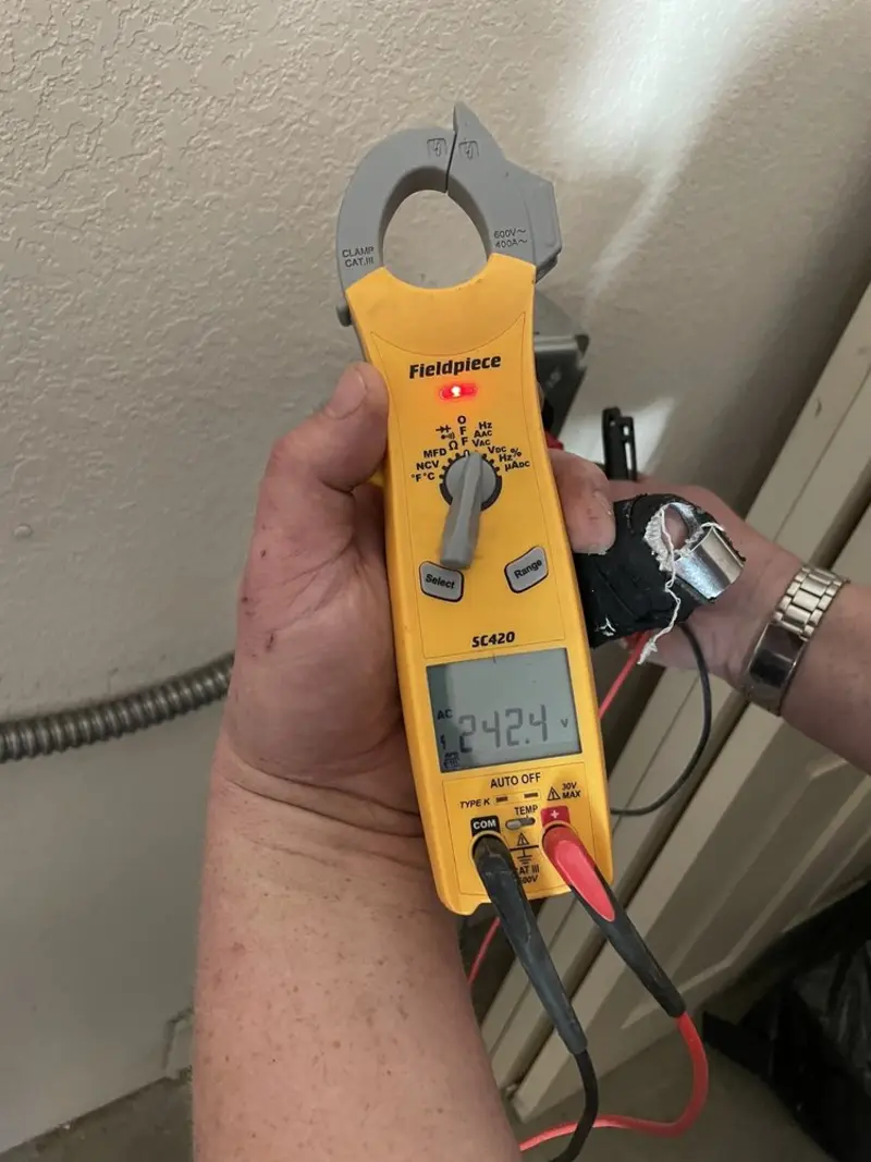 Voltage testing with clamp meter during Electrical Installation Services in Cooper